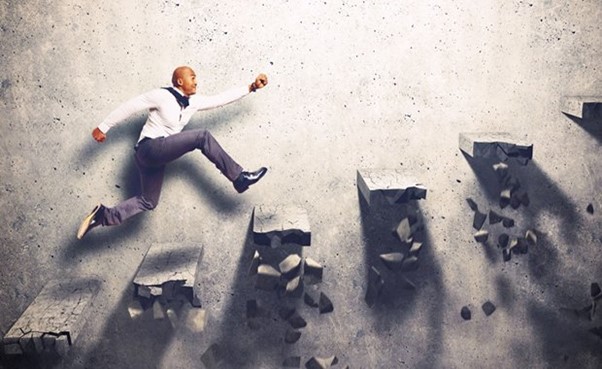 Businessman rising up with determination after failure, symbolizing resilience and perseverance in entrepreneurship
